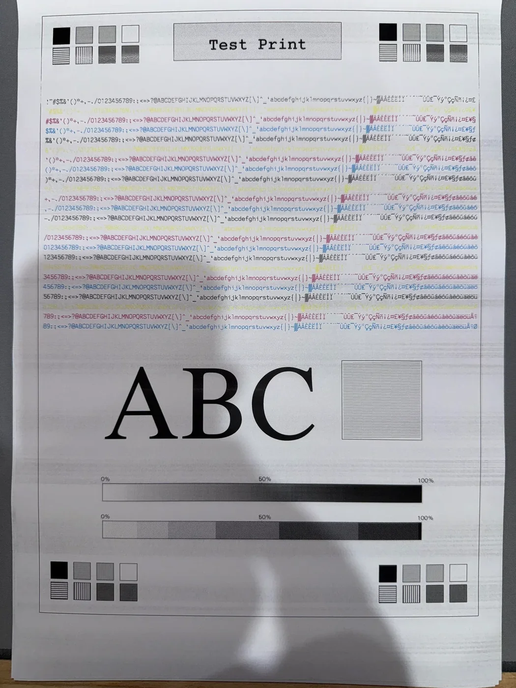 Photographed printer test page showing horizontal banding